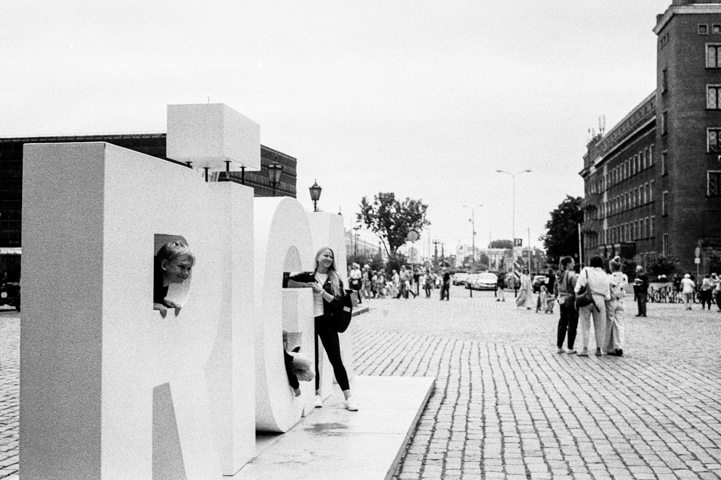 People peek and pose through giant RIGA letters.